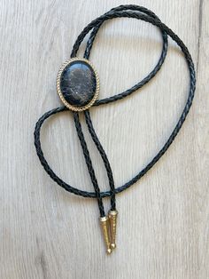 "This awesome bolo tie has a southwestern design and agate stone centerpiece with white veins.  The cord is genuine leather and the metal is gold toned. Our bolos pair nicely with many of our belt buckles! They make wonderful gifts.    The western bolo tie rope length is 100cm(39\")  and the stone is approx 2''x 1 1/2''" Western Style Gold Lariat Jewelry, Concho Jewelry For Rodeo, Southwestern Style Adjustable Bolo Ties, Western Style Concho Jewelry As Gift, Western Style Concho Jewelry For Gift, Adjustable Concho Jewelry For Rodeo, Vintage Concho Lariat Necklace, Vintage Style Concho Lariat Necklace, Adjustable Gold Concho Jewelry