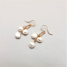 Three stones dangle from brass chain.  Great for all ages, these simple earrings are easily dressed up or down.     All pieces will be packaged together in a cotton filled jewelry box unless otherwise specified. Please let us know if your order is a gift and we will gladly include a handwritten note and complimentary g Nickel-free 14k Gold-filled Pearl Earrings, Gold Hypoallergenic Dangle Jewelry, Minimalist 14k Gold-filled Dangle Jewelry, Gold Plated Dangle Jewelry Gift, Gold Plated Dangle Jewelry For Gifts, Hypoallergenic Gold Dangle Jewelry, Classic Brass Jewelry With Ear Wire, Handmade White Pearl Earrings In 14k Gold Filled, Adjustable Pearl Drop Jewelry As Gift