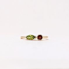 Natural Fine Peridot Garnet Marquise and Round Cut Ring. Semi Precious Gemstone Ring in 14k SOLID GOLD For Her from our Capsule Jewelry Collection. Peridot and Garnet Gemstones are set in  Bezel Setting in our Factory. Gold Ring AA+ Quality. Perfect Gift For Everyday or August Birthstone Gift for Your Loved Ones. ►  DIMENSIONS : ◆ Gemstone : Peridot 0.30 Cts                         : Garnet 0.10 Cts ◆ Stone size : Peridot  6*3 mm                                          : Garnet  3*3 mm ◆ Shank Width : 1 mm      ◆  Material :  14k Yellow Gold          Made to Order      EACH Ring is Stamped With 585 Marked As 14k GOLD International Standard. All my gemstones are hand-selected for best quality assurance, then precisely sawed, and shaped into the desired geometry. The Semi precious stones ar Mixed Gemstone Rings Garnet Peridot And Diamond Heart Shape, Fine Jewelry Marquise Multi-stone Ring, Unique Multi-stone Birthstone Promise Ring, Green Multi-stone Marquise Jewelry, Fusion Style Stackable Ring Jewelry, Fusion Style Green Rings With Accent Stones, Fusion Style Wedding Ring With Birthstone, Green Fusion Style Rings With Accent Stones, Green Fusion Rings With Accent Stones