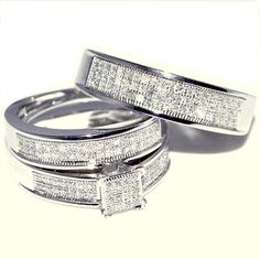 two white gold wedding rings with diamonds on each one and an invisible band around them