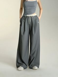 Unwind in style with our Relaxed Fit Drawstring Waist Wide Leg Pants. These pants offer the perfect combination of comfort and fashion, with a relaxed fit and adjustable drawstring waist. The wide leg design adds a trendy twist to any look. Get ready to lounge or hit the town in these versatile pants. Material: 60% Polyester 35% Cotton 5% Spandex Size Chart: Size Waist (cm) Hip (cm) Length (cm) S 64 100 104 M 68 104 105.5 Note: All measurements are in centimeters (cm). Baggy Wide-leg Harem Pants For Leisure, Baggy Wide Leg Harem Pants For Leisure, Baggy Harem Pants With Drawstring For Loungewear, Baggy Drawstring Harem Pants For Loungewear, Solid Color Wide Leg Pants For Spring Leisure, Spring Solid Color Wide Leg Leisure Pants, Spring Ankle-length Parachute Pants With Drawstring, Trendy Gray Pants With Drawstring, Relaxed Fit Wide Leg Bottoms With Drawstring