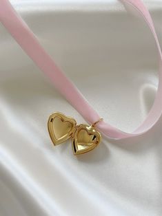 Oh it’s love... Introducing the most heavenly necklace to ever exist! Handcrafted with stunning pale pink velvet and your choice of a 14K gold or stainless steel heart locket, the 'FOREVER YOURS' is bound to become a treasured piece in your jewelry collection. Trust us, compliments are coming your way! Made with vintage, deadstock pale pink velvet and 14K gold plated or stainless steel locket. 45" length - designed to allow you to tie this piece in multiple ways. Handmade with love in Los Angele Rose Gold Locket For Valentine's Day, Rose Gold Heart Charm Pendant Locket Necklace, Rose Gold Heart Charm Locket Necklace, Rose Gold Heart Locket Jewelry, Heart-shaped Rose Gold Locket Jewelry, Rose Gold Heart-shaped Locket Jewelry, Dainty Rose Gold Locket Necklace For Valentine's Day, Rose Gold Jewelry For Valentine's Day Keepsake, Wedding Locket Necklace With Charms For Valentine's Day