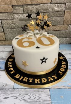 a white and gold 60th birthday cake with stars