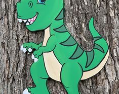 a green and white dinosaur standing on its hind legs next to a tree with it's mouth open