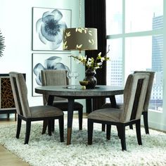 a dining room table and chairs in front of a large window