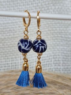 We combine art and elegance to create this beautiful piece. Our handmade earrings will be the perfect element to make your outfit standout. You could have the entire collection or gift them to someone special.  Material: Real Gold plate brass, Talavera gemstone  Dimensions: Drop Length 5cm, weight 2g Features : Lightweight, Unique and Simple design The Talavera of Puebla is part of the intangible heritage of humanity, declared by UNESCO. It is a type of majolica ceramic with a mixture of Chinese, Italian, Spanish, and indigenous techniques, and its colors are obtained from natural pigments. Its main characteristics are its vitreous finish and the use of bulky cobalt blue, this made it even more exclusive and ostentatious than Spanish craftsmanship. Its production requires at least 120 hour Handmade Tassel Earrings As Gift, Elegant Blue Tassel Earrings As Gift, Elegant Blue Tassel Earrings For Gift, Handmade Artisan Tassel Earrings, Handmade Bohemian Dangle Clip-on Earrings, Handmade Bohemian Drop Clip-on Earrings, Artisan Handmade Tassel Earrings For Gift, Bohemian Handmade Drop Clip-on Earrings, Handmade Artisan Tassel Earrings As Gift