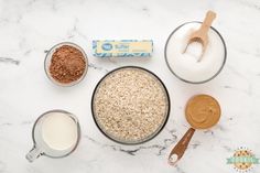 ingredients to make oatmeal are displayed on a marble surface