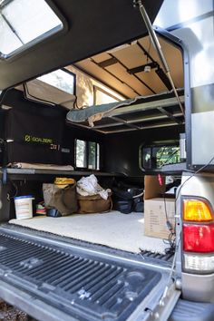 the back end of a truck with its cargo compartment open