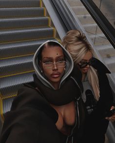 two women are standing on an escalator