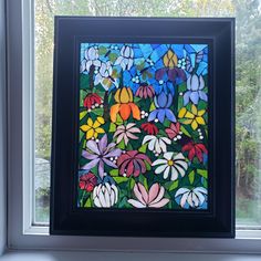 a stained glass window with flowers on it