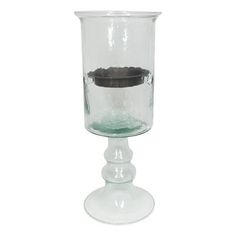 a clear glass vase with a black lid and base on a white background, it appears to be used as a candle holder