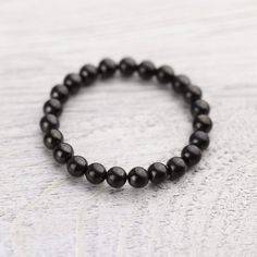 Wrist Malas Shungite Protection Bracelet Minimalist Black Bracelet For Meditation, Minimalist Black Bracelets For Meditation, Minimalist Black Beaded Bracelets For Meditation, Minimalist Black Healing Bracelet, Black Obsidian Stretch Bracelet With Round Beads, Black Stretch Bracelet With 8mm Beads Spiritual Style, Black Stretch Bracelet With Gemstone Beads For Healing, Adjustable Black Obsidian Stretch Bracelet, Black Stretch Bracelet With Natural Stones For Healing