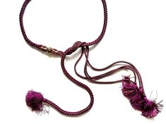 a purple rope with tassels on it