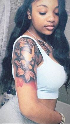 a woman with a flower tattoo on her arm