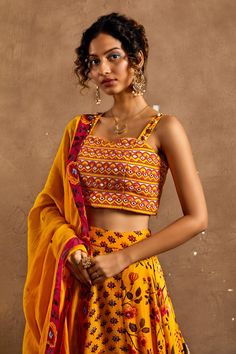 Yellow lehenga with floral, lotus print all over. Paired with mirror, scallop embroidered blouse and dupatta.
Component: 3
Pattern: Printed, Embroidery
Type Of Work: Floral, lotus, mirror, scallop
Neckline: Sweetheart
Sleeve Type: Sleeveless
Fabric: Lehenga and Blouse: Cotton Silk, Dupatta: Chanderi
Color: Yellow
Other Details: 
Strap embroidery
Occasion: Destination Wedding - Aza Fashions Fitted Pre-draped Saree With Motifs For Festivals, Yellow Choli With Motifs For Puja, Bohemian Fitted Lehenga With Bandhani Print, Fitted Bohemian Lehenga With Bandhani Print, Fitted Bohemian Bandhani Print Lehenga, Fitted Sharara For Puja, Diwali Fitted Pre-draped Saree With Motifs, Fitted Sets With Dupatta For Puja, Yellow Bandhani Print Choli