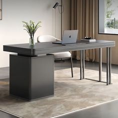 an office desk with a laptop on it