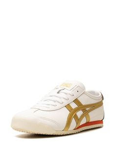 Onitsuka Tiger's signature Mexico 66 sneakers spotlight elements borrowed from the original 1961 LIMBER-UP training shoe: think the panelled upper and iconic Tiger Stripes at the sidewall. This “White/Gold” iteration is crafted from leather and finished with contrasting branded details. White Retro Custom Sneakers For Sports, Retro White Custom Sneakers For Sports, Retro White High-top Sneakers With Rubber Sole, Retro White Sneakers With Contrast Sole, White Retro Sneakers With Contrast Sole, Retro White Sneakers With Rubber Waffle Outsoles, Retro Leather Sneakers For Jogging, Classic White Sneakers With Gum Sole, White Sporty Sneakers With Gum Sole