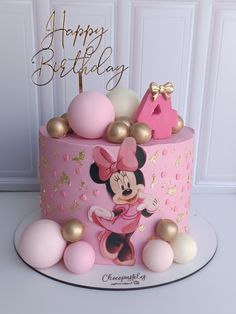 a pink and gold minnie mouse birthday cake