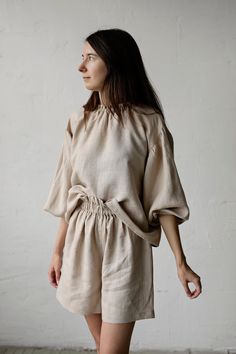 "Tokyo tunic is made from 100% soft and washed linen. Details: - Colour: Sand - Composition: 100% Oeko-Tex certified linen - Ruffle neckline - Dropped shoulders - Long sleeves - Loose fit - Medium weight linen - Linen care: machine wash gentle; tumble dry low, ironing optional - The price is for one tunic, other pictured items are not included The model is 170 cm/5'7\" and wears a size S." Relaxed Fit Beige Ramie Tops, Beige Relaxed Fit Ramie Top, Relaxed Fit Linen Blouse In Flax Color, Relaxed Fit Ramie Blouse For Daywear, Relaxed Fit Ramie Tops For Daywear, Beige Relaxed Fit Tunic Blouse, Beige Linen Tunic With Relaxed Fit, Daywear Linen Top In Flax Color, Daywear Flax Linen Tops