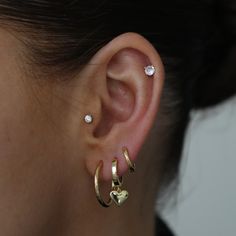 a close up of a person's ear with two different types of piercings