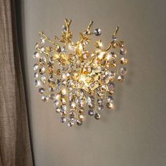 a gold and crystal chandelier hangs on the wall