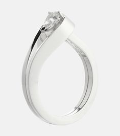 a white gold ring with a single diamond