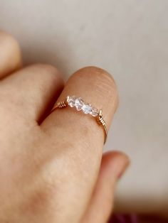 Petite and dainty raw crystal ring with Herkimer diamond ✨ Handmade in 14K Gold Filled, Rose Gold Filled, Sterling Silver, April birthstone gift 🖤 Simple design stacking ring with genuine Herkimer diamond. Very dainty and cute ring for everyday wear. *Gemstone Size: 2-3 mm *Ring Band:  0.8 mm  * Handmade in your ring size natural gemstones and 14K gold-filled, rose gold filled or sterling silver. * Gold-filled and sterling silver are known for their lasting quality. This ring won't tarnish and Delicate 14k Gold Promise Crystal Ring, Delicate 14k Gold Crystal Promise Ring, Delicate Crystal Ring With Rose Cut Diamonds For Gift, Dainty Rose Gold Crystal Anniversary Ring, Dainty Birthstone Ring With Rose Cut Diamonds As Gift, Delicate Rose Cut Diamonds Jewelry For Promise, Dainty Rose Gold Crystal Ring With Birthstone, Delicate White Topaz Jewelry With Rose Cut Diamonds, Dainty Rose Gold Crystal Birthstone Ring