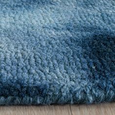 an area rug with blue and gray colors on the floor, closeup view from above