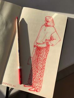 a drawing of a woman in red and white pants, with a pencil next to it