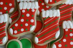 decorated christmas cookies with green and white decorations on them, all in red and green