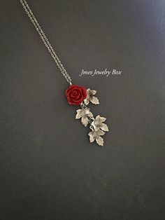 Beautiful red resin rose with dangling silver leaves. Detailed stainless steel leaves measure 15.5mm x 11mm. Total pendant length with rose and leaves is just over 2 inches. This necklace is 18'' long with lobster clasp. *15mm Resin rose *Stainless steel chain *Stainless steel leaves *Handmade with love <3 Like Jmesjewelrybox on Facebook for updates on new jewelry, upcoming sales and giveaways! Plus Facebook fans save 5% :D Find the coupon code on Jmesjewelrybox's cover photo https://www.face Silver Rose Earrings, Red Rose Necklace, Rose Jewelry Flower, Black Rose Jewelry, Rose Necklaces, Red Rose Jewelry, Rose Branch, Rose Accessories, Resin Rose