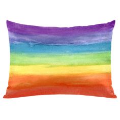 an orange, yellow and blue pillow with watercolor stripes on the front in bright colors