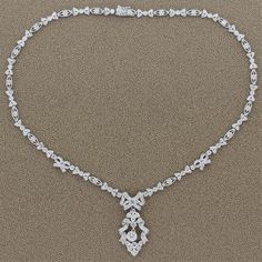 For Sale on 1stDibs - A feminine necklace made in Edwardian style featuring a 0.54 carat round cut diamond drop. The ribbons and bows of this platinum necklace are studded with Vintage Diamond Necklace, Victorian Pendant Necklace, Platinum Necklace, Art Deco Pendant Necklace, Feminine Necklace, Victorian Pendants, Art Deco Brooch, Edwardian Style, Filigree Necklaces