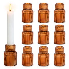 a set of twelve wooden candlesticks with a lit candle in the middle one