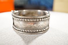 I am offering you this lovely vintage sterling silver classic raised relief design bangle bracelet. It features incredible art deco style design work, all with a very uniform eternity style etched designs that around the entire top surface of this very high-end spectacular bangle bracelet . It measures app. 2.5 inches in diameter. This gorgeous wide vintage bangle bracelet came fresh out of an estate here in upstate New York, where I uncovered several wonderful vintage pieces of jewelry, this ba Classic Round Ceremonial Cuff Bracelet, Classic Round Cuff Bracelet For Ceremonial Occasions, Classic Hallmarked Bangle For Ceremonial Occasions, Victorian Silver Jewelry With Decorative Band, Classic Silver Ceremonial Bangle, Vintage Sterling Silver Bangle For Ceremonial Occasions, Vintage Etched Sterling Silver Bangle Bracelet, Antique Sterling Silver Bracelet Stamped 925, Etched Sterling Silver Bangle Bracelet Vintage Style