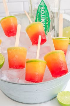 watermelon and lime popsicles on ice in a bucket