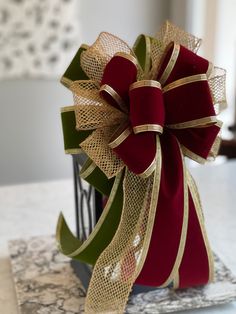 a red and gold bow sitting on top of a table