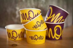 five mcdonald's cups are stacked on top of each other in purple and yellow