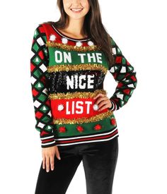 a woman wearing an ugly christmas sweater with the words on the nice list