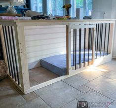 a dog bed that is in the middle of a room with tile flooring and walls