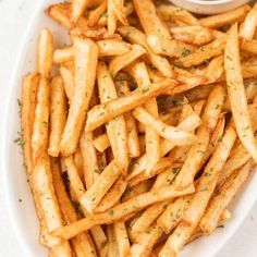 french fries on a plate with dipping sauce