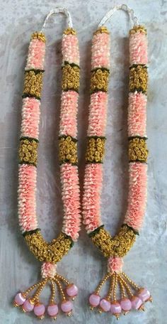 three pink and gold necklaces with beads