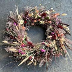 a dried wreath is sitting on the ground