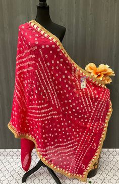 The Bandhani Dupatta is a beautifully crafted accessory that is perfect for any celebration attire. With its stunning multi-color prints and intricate Gota Patti embellishments, this dupatta is both trendy and stylish. Its light-weight design makes it comfortable to wear, while its ethnic look adds a touch of traditional elegance to any outfit. Whether you are attending a party or simply looking for a classy addition to your wardrobe, this designer dupatta is an excellent choice. Shop now for a stunning ethnic wear accessory that is sure to turn heads. Bohemian Bandhani Traditional Wear For Festivals, Bohemian Traditional Wear With Bandhani Print For Festivals, Semi-stitched Bandhani Print Choli For Festive Occasions, Festive Bandhani Print Lehenga, Festive Art Silk Choli With Bandhani Print, Red Bandhani Print Dupatta For Festive Occasions, Bandhani Print Dupatta For Navratri Party, Navratri Party Dupatta With Bandhani Print, Navratri Party Bandhani Print Dupatta