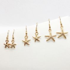 Earrings Starfish Beach Seashells Gold Tone Sea Shore Ocean Nautical Cruise Jewelry 3 Pack Handmade With Love By Me. No Flaws, No Returns. Gold Tone Charms On Hypoallergenic Earring Wires. [Earrings Starfish Beach Seashells Gold Tone Sea Shore Ocean Nautical Cruise Jewelry 3 Pack Minimalist Bohemian Summer Vacation Seaside] Star-shaped Summer Beach Jewelry, Summer Starfish Charm Star-shaped Jewelry, Summer Starfish Charm Star Shaped Jewelry, Summer Star-shaped Starfish Charm Jewelry, Beach Jewelry With Starfish Charm, Gold Starfish Jewelry For Vacation, Gold Nautical Jewelry For The Beach, Gold Nautical Jewelry For Beach, Ocean-inspired Star Shaped Jewelry For The Beach