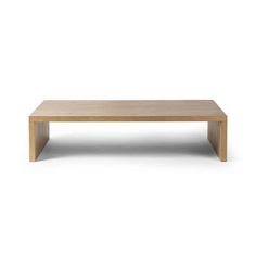 a wooden coffee table sitting on top of a white floor