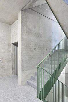 an empty concrete building with stairs leading up to the second floor