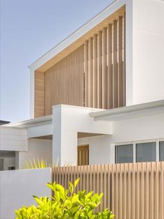 a white house with wooden slats on the front and side walls, in australia