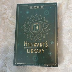 the harry potter library book is laying on a white furnishing area with it's cover open