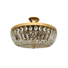 a golden ceiling light with crystal beads hanging from it's center point, on an isolated white background